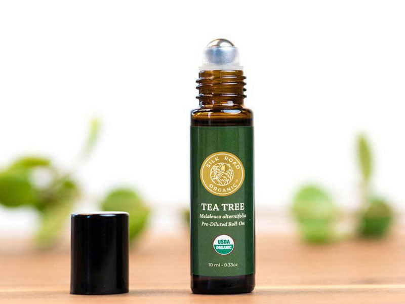 Silk Road organic tea tree essential oil roll-on with cap removed