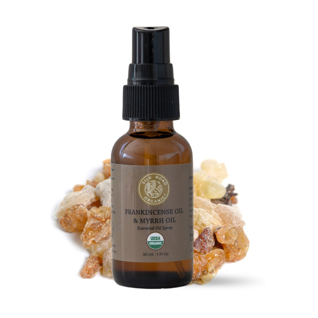 Bottle of frankincense and myrrh oil with frankincense resin on a white background