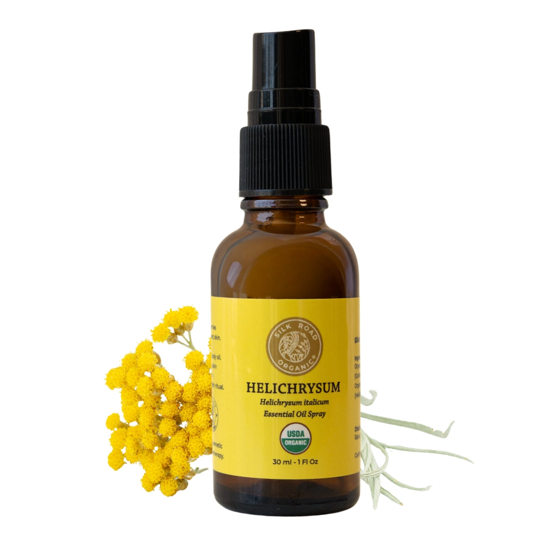 Helichrysum essential oil spray bottle with yellow flowers on a white background