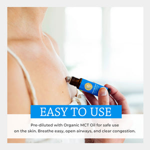 Bottle of essential oil held by a hand with text about its use on skin. easy safe apply touch stick how use diluted carrier topical fractionated coconut apply chest rub inhale vapor