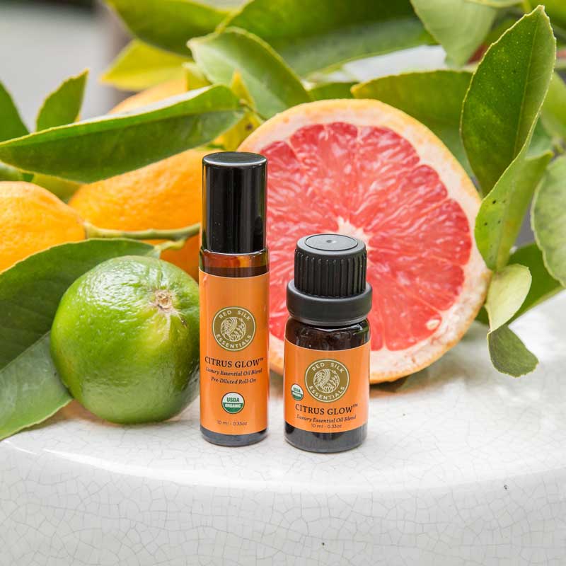 essential oils for energy & focus red silk essentials organic citrus glow roll-on and undiluted bottle