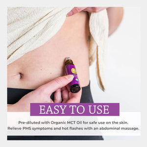 Person holding a rollerball with text about its use for PMS symptoms. easy apply directly skin diluted safe use rub stomach belly pulse points breathe deep scent