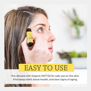 Woman applying a bottle of organic frankincense oil to her temple with text about its benefits. easy apply pre-diluted reduce appearance stretch marks scars achieve healthy looking skin