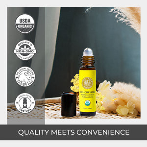 Roll-on bottle of Helichrysum oil with USDA Organic and Non-GMO labels on a soft natural background. pure premium quality floral roll on stainless rollerball amber glass best variety ease tension