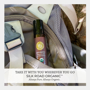 Silk Road Organic patchouli essential oil bottle in a bag with promotional text.