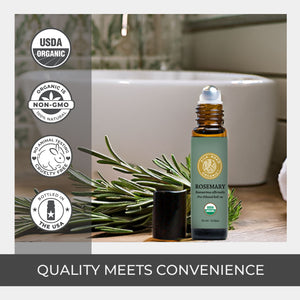 Roll-on bottle of rosemary essential oil with greenery and certification logos on a bathroom counter. stainless steel rollerball no leak quality convenience amber glass usda certified