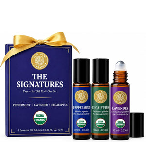 the signatures essential oil roll-on gift set box with gold bow and peppermint eucalyptus and lavender roll-ons